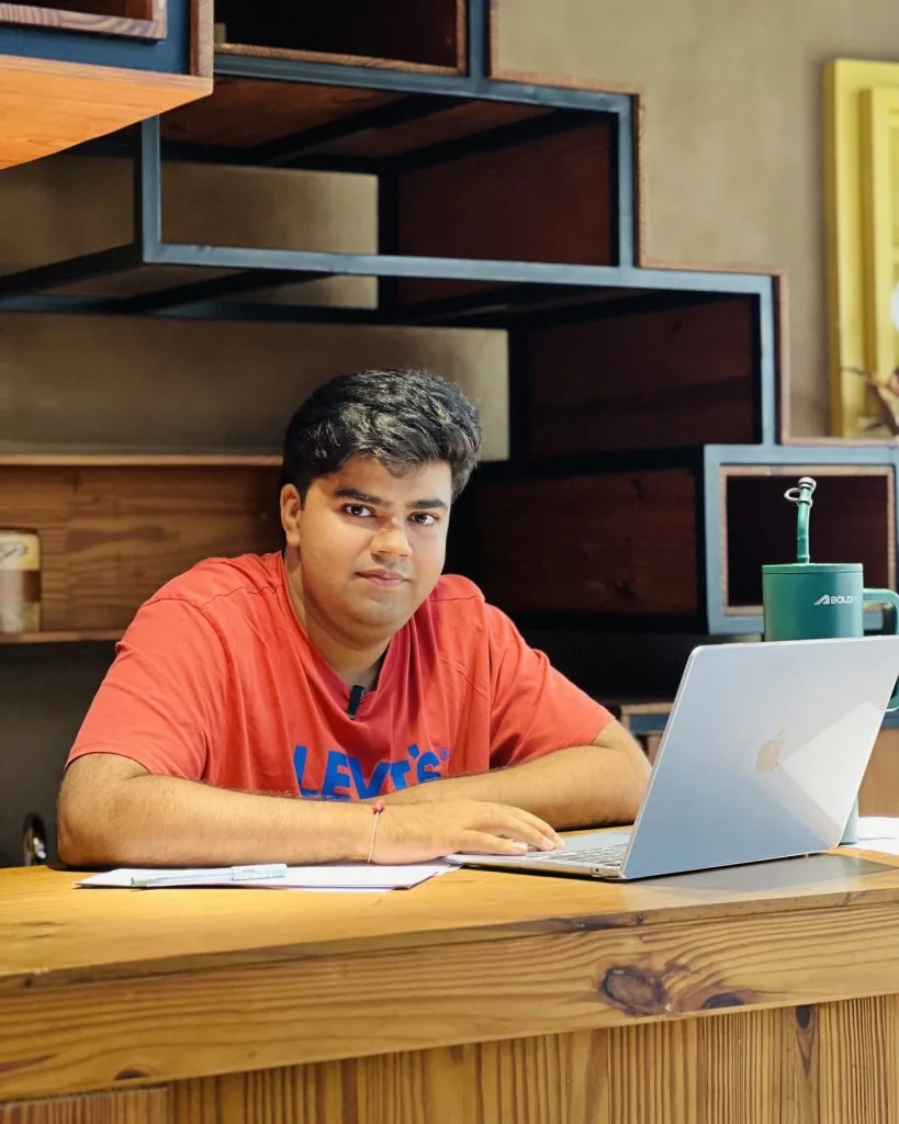 Portrait of the founder of Ondrea, seated at a workbench